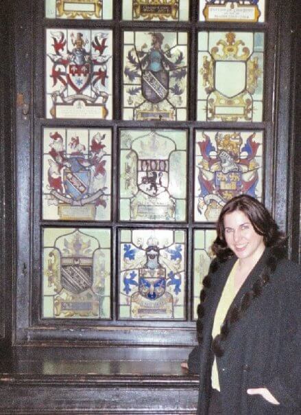 Caitlin McCarthy standing beside the stained glass window for Sir Charles Dodds (creator of DES) at the Worshipful Society of Apothecaries of London